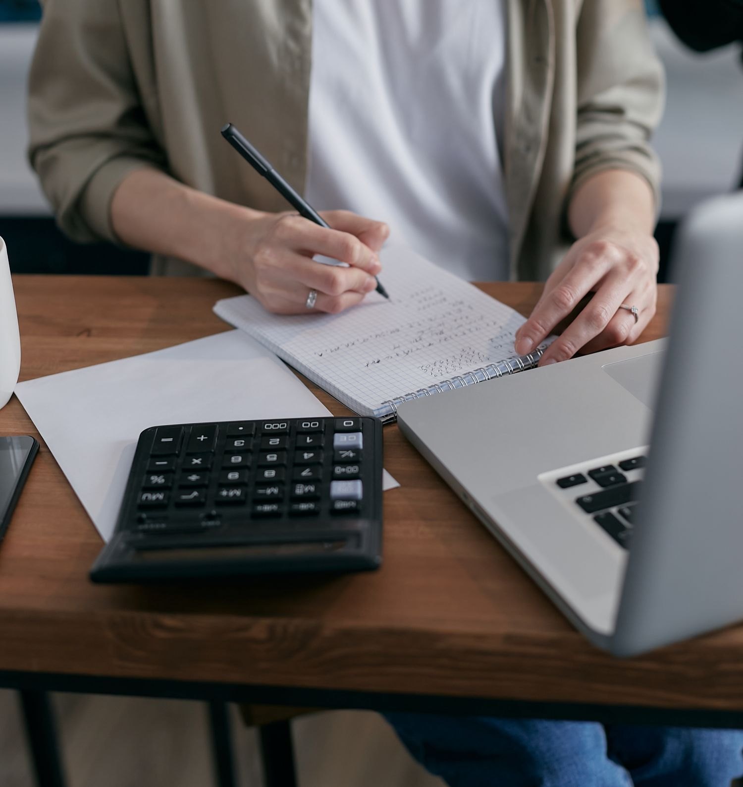 A notebook and calculator used for budgeting