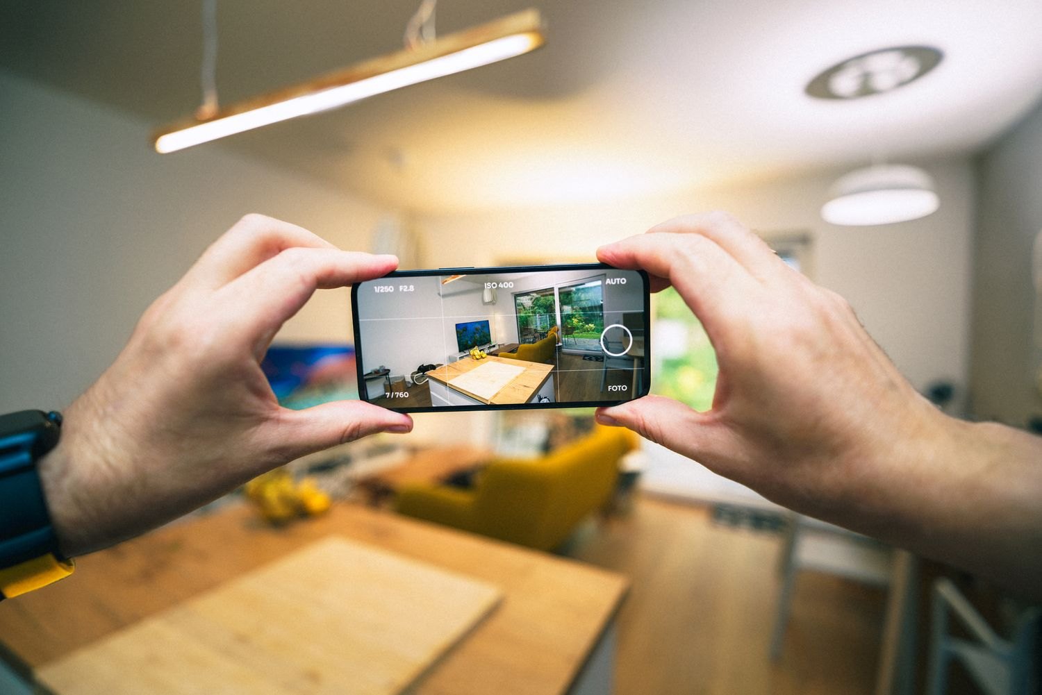 A smartphone photographing a room interior