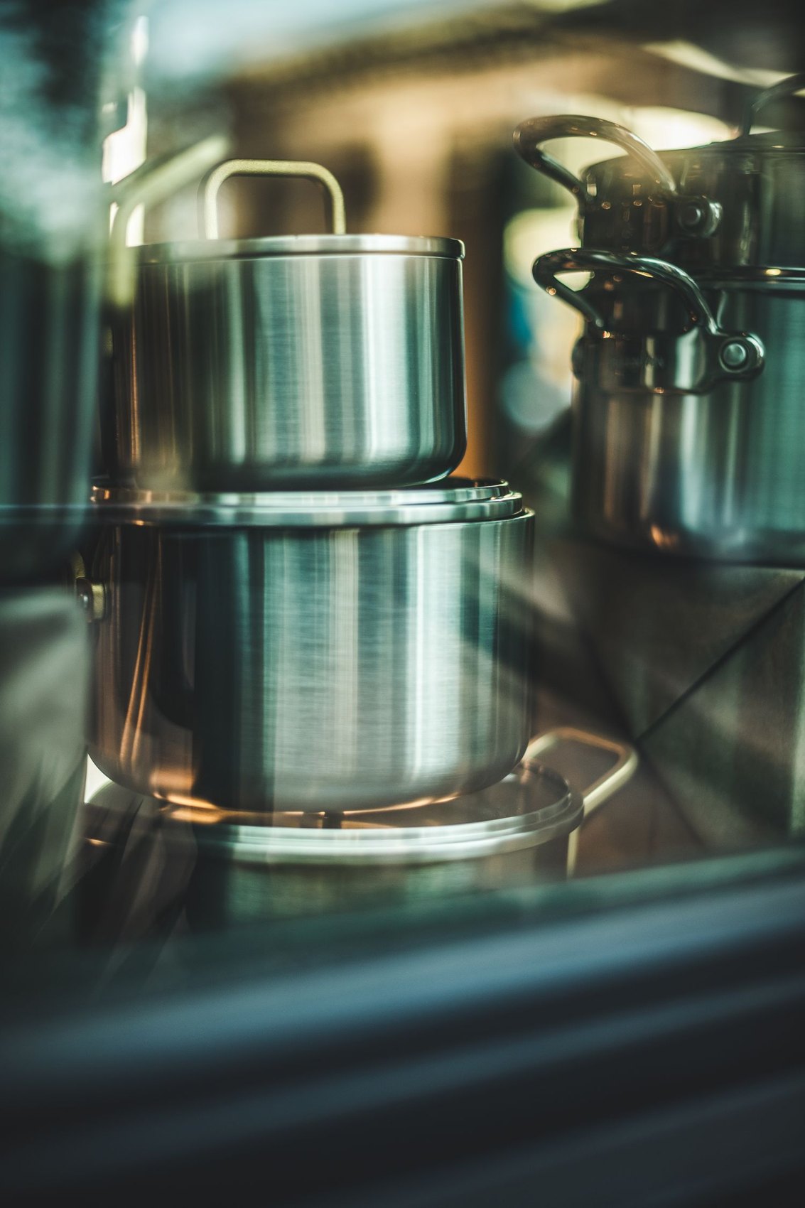 Stacked stainless steel pots in a kitchen