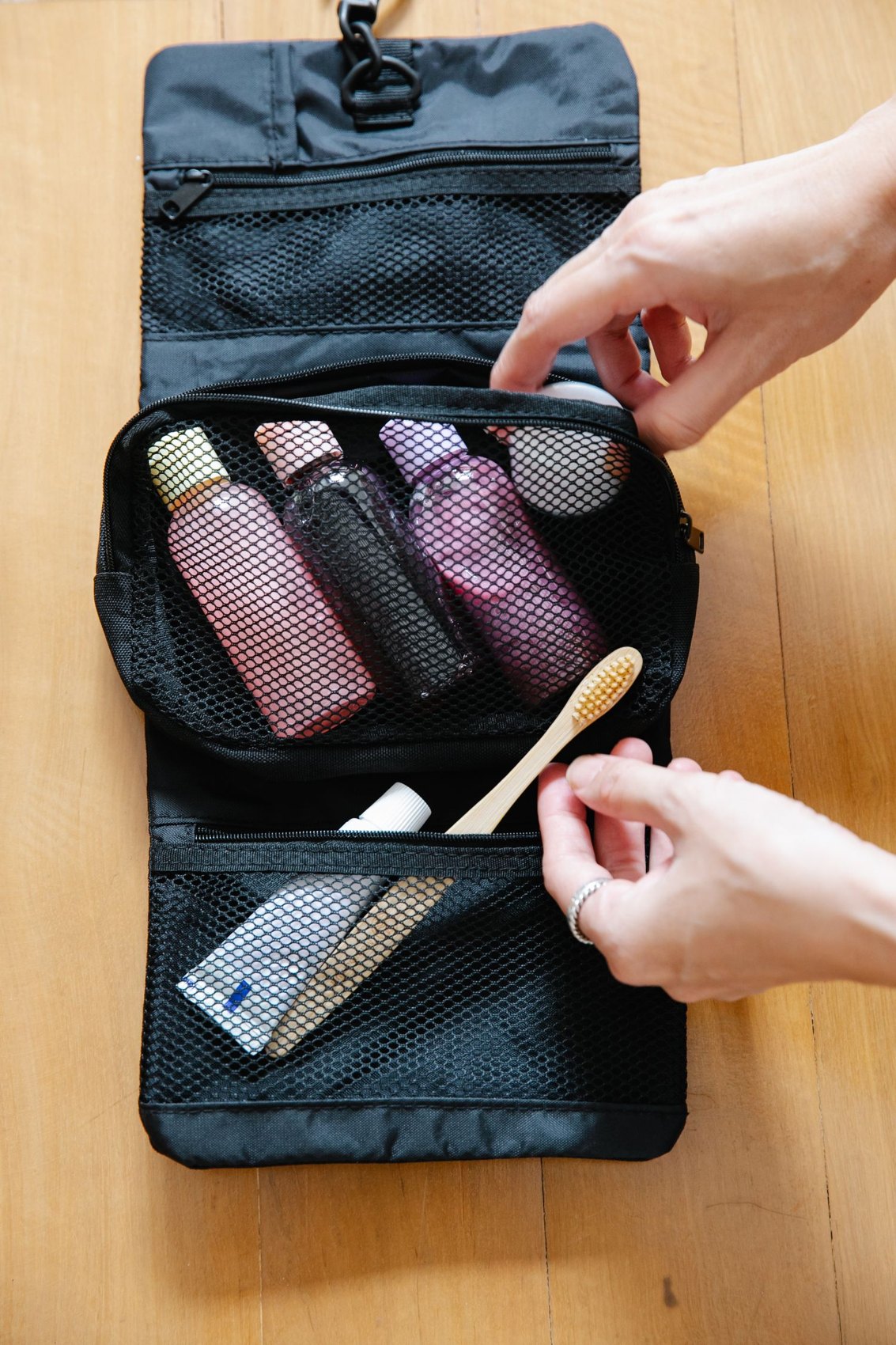 An open toiletry bag with bottles and a toothbrush