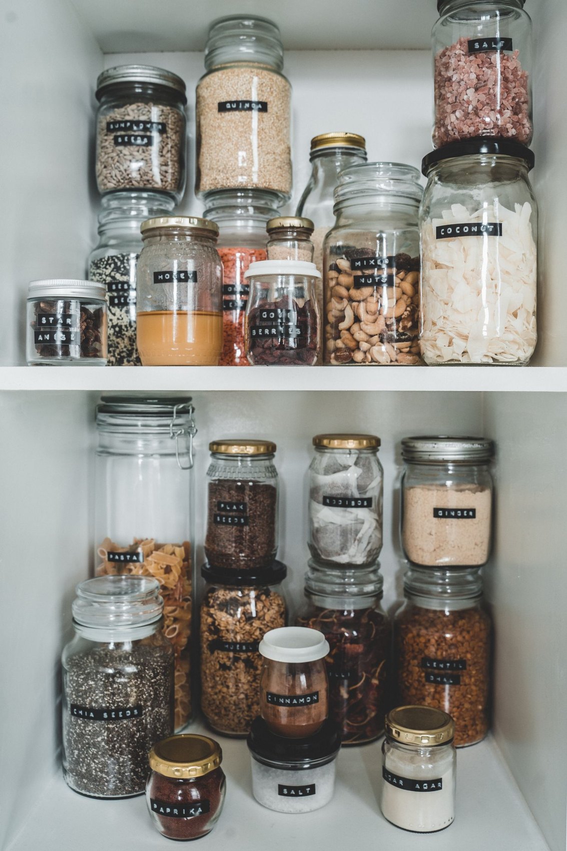 Pantry supplies in labelled glass containers on shelves