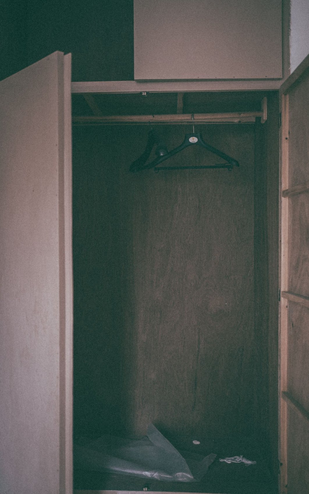 An open empty wardrobe with hangers