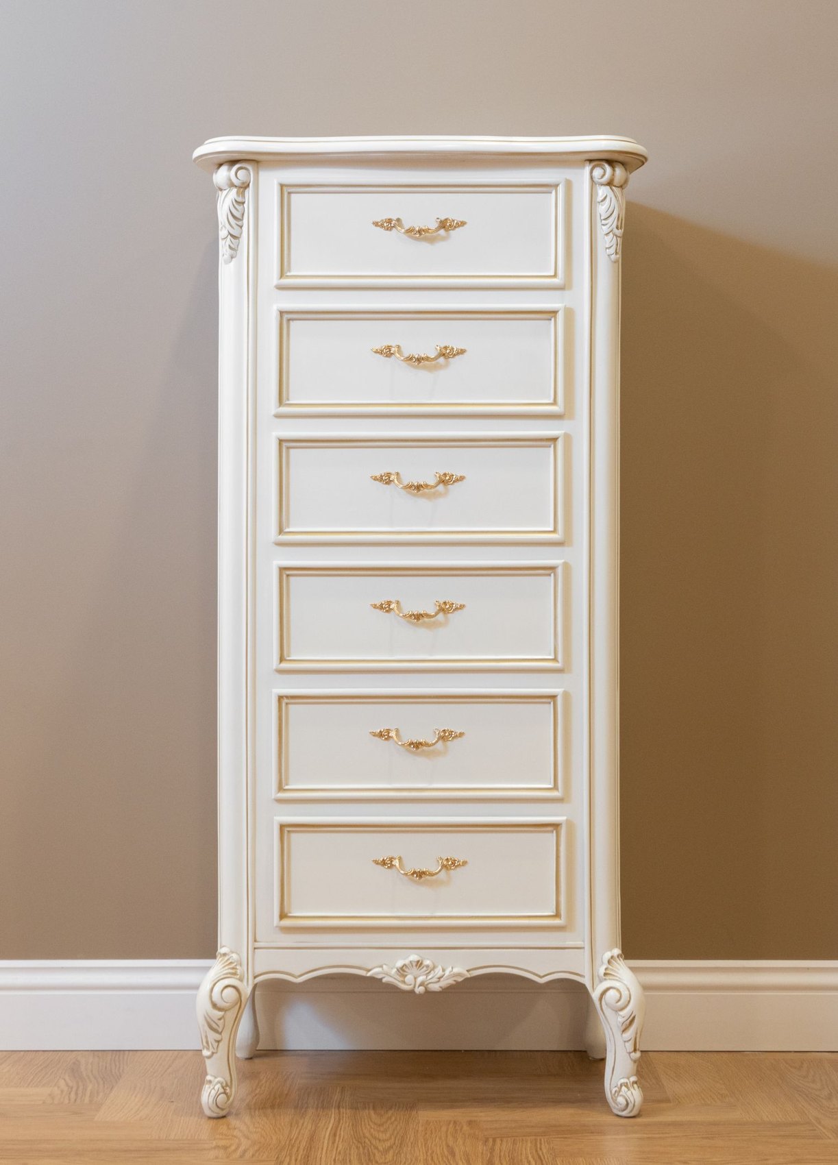 A white chest with several drawers