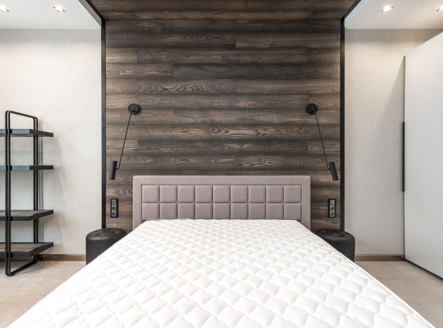 An uncovered mattress in a bedroom