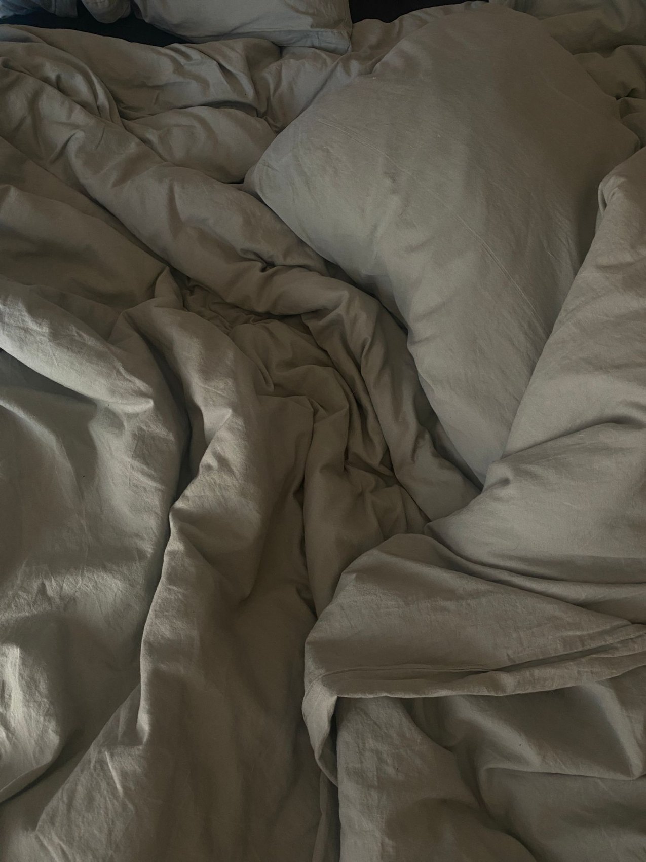 Pale bed linen and pillows on a bed