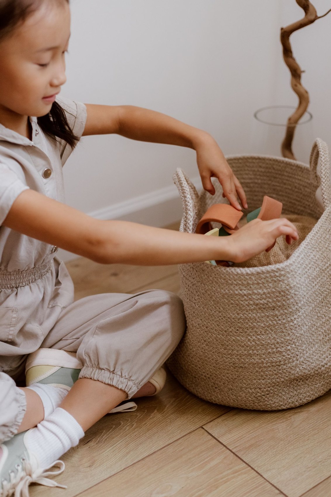 A child sorting toys into a basket