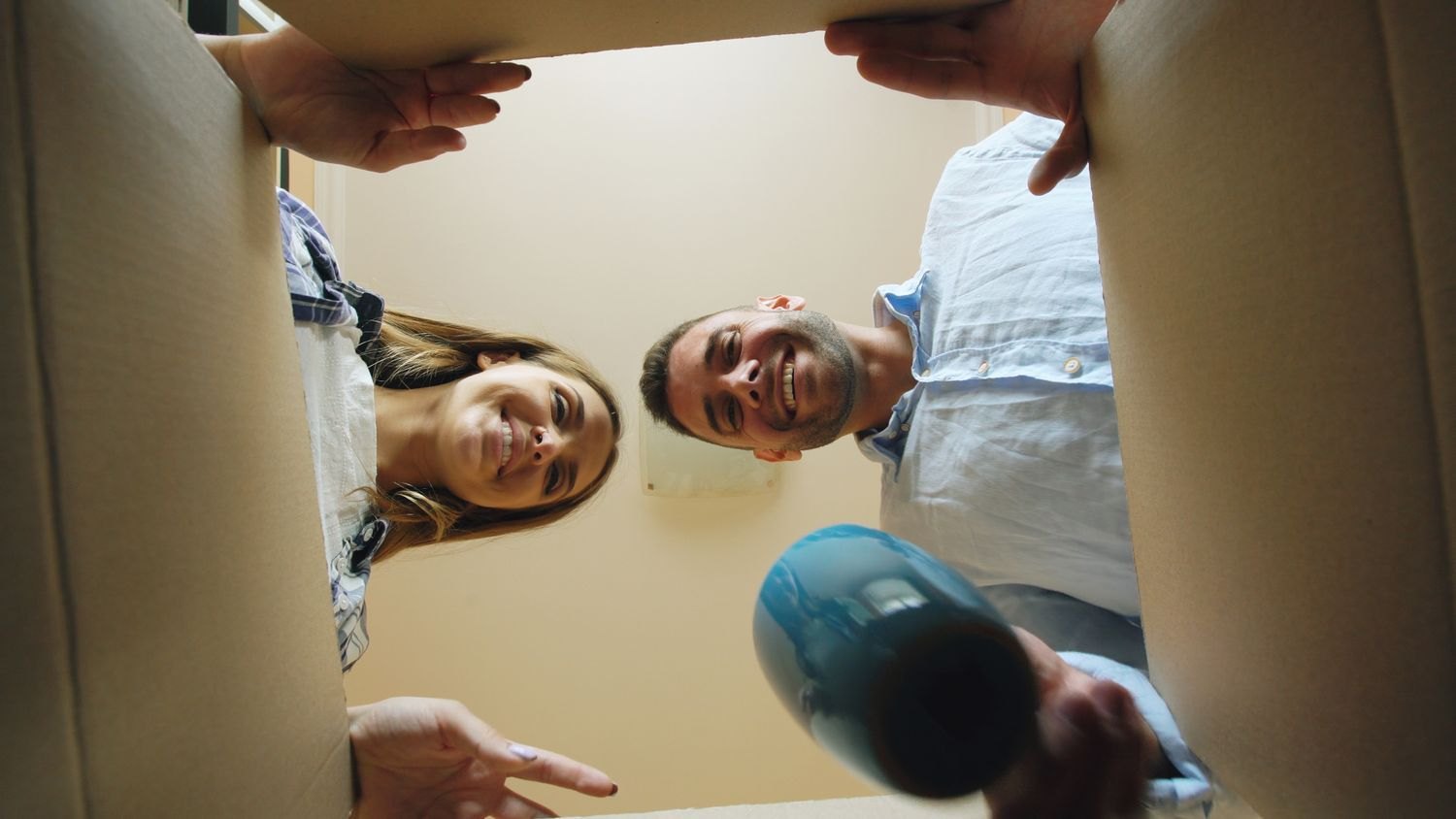 A couple looking into an open moving box
